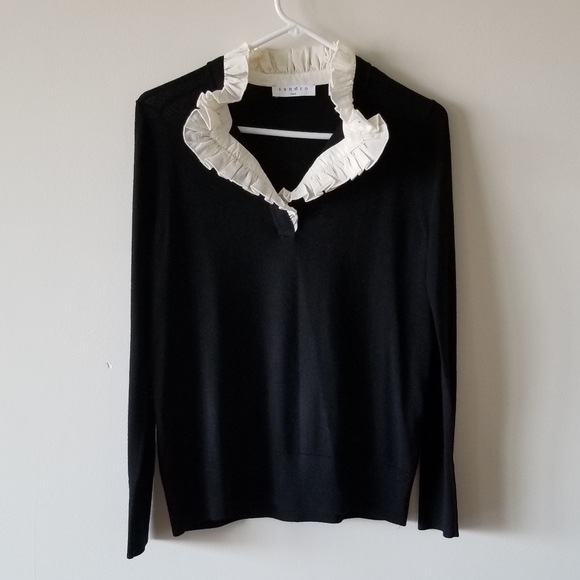 black sweater with white ruffle collar